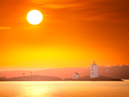 Throughout the year, the sun can be seen rising behind Dutch Island Lighthouse.