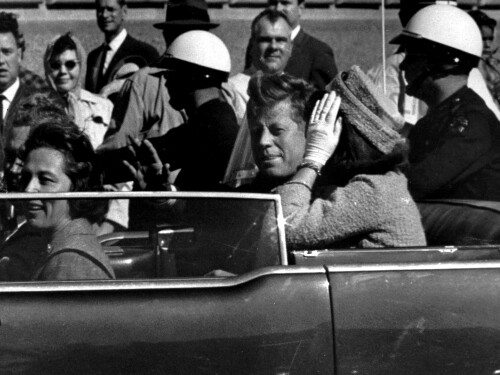 FILE - President John F. Kennedy waves from his car in a motorcade approximately one minute before he was shot, Nov. 22, 1963, in Dallas. Riding with President Kennedy are first lady Jacqueline Kennedy, right, Nellie Connally, second from left, and her husband, Texas Gov. John Connally, far left.