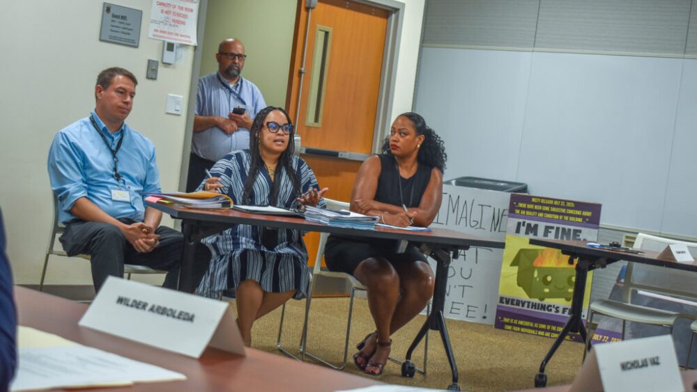 Rhode Island Department of Children, Youth and Families Chief of Staff Misty Delgado, center, speaks before the State Properties Committee during its special meeting on Tuesday, July 29, 2025. At left is Adam Boudreaux, the Department of Administration’s chief property manager. At right is DCYF Director Ashley Deckert.