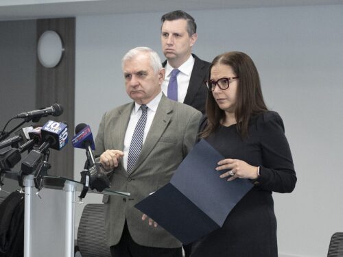 U.S. Rep. Seth Magaziner, center back, and U.S. Sen. Jack Reed, left, join Rhode Island Commissioner of Elementary and Secondary Education Angélica Infante-Green as she prepares to answer a reporter’s questions during a press conference at the National Education Association of Rhode Island headquarters in Cranston on Monday, Feb. 17, 2025.
